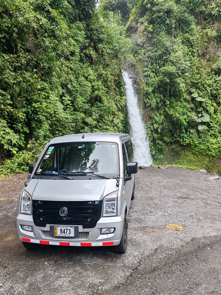 TicoTrekker van stopped in front of a waterfall